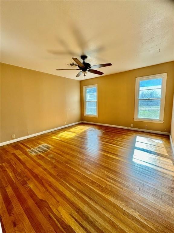 empty room featuring ceiling fan and hardwood / wood-style floors