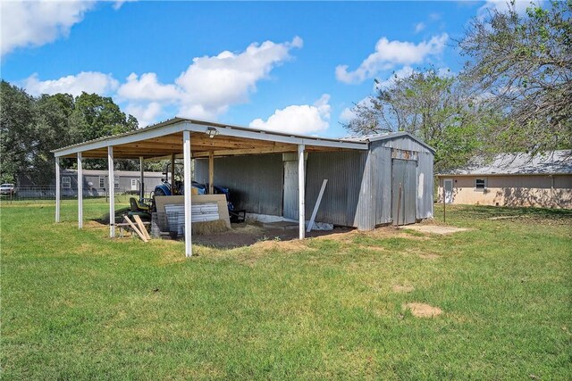 view of outbuilding featuring a yard