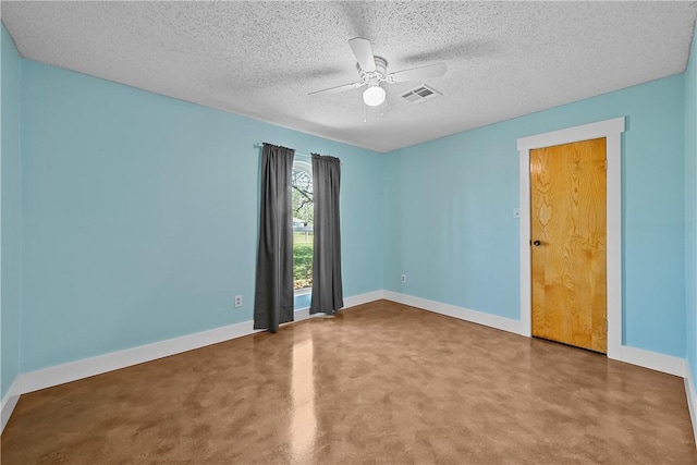 unfurnished room with ceiling fan and a textured ceiling