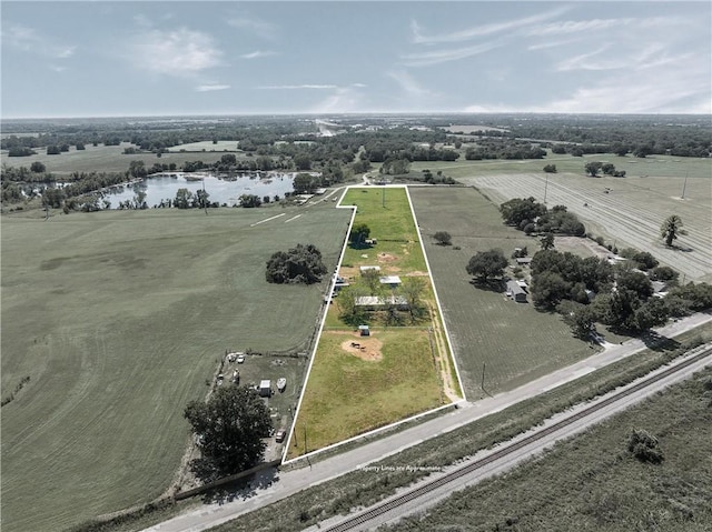 birds eye view of property with a rural view and a water view