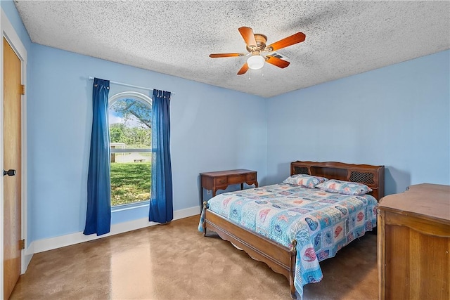 bedroom with carpet flooring, multiple windows, ceiling fan, and a textured ceiling