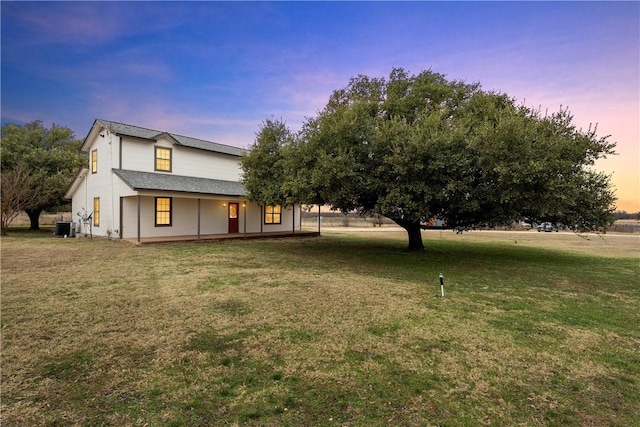 exterior space featuring a lawn and cooling unit