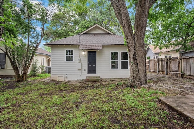 bungalow-style house with cooling unit