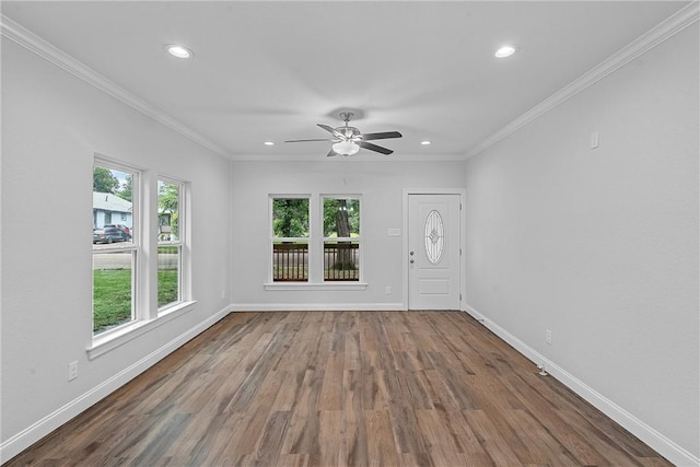 empty room featuring crown molding, ceiling fan, and wood-type flooring