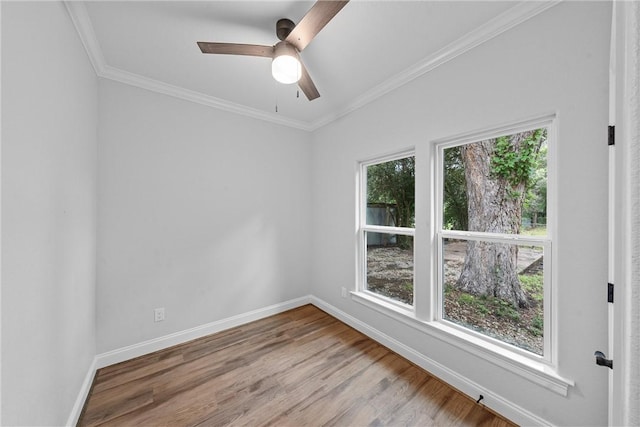 unfurnished room with crown molding, wood-type flooring, and a wealth of natural light