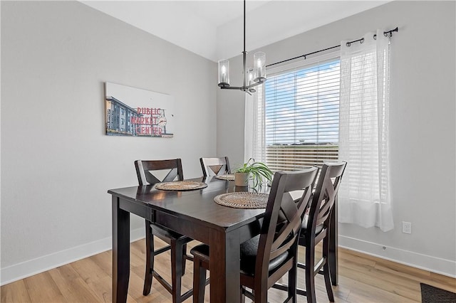 dining space featuring a notable chandelier and light hardwood / wood-style flooring