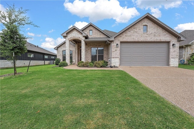 view of front of property featuring a garage and a front lawn