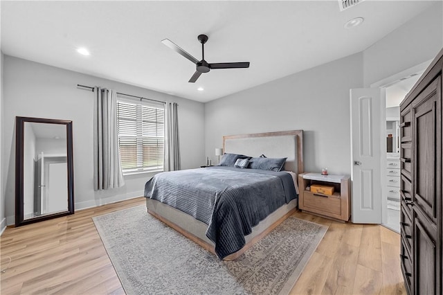 bedroom with light hardwood / wood-style flooring and ceiling fan