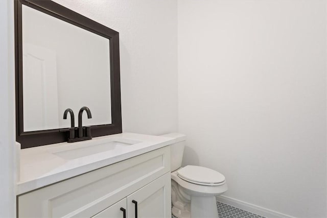 bathroom featuring tile patterned floors, vanity, and toilet