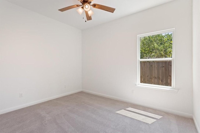 spare room with light colored carpet and ceiling fan