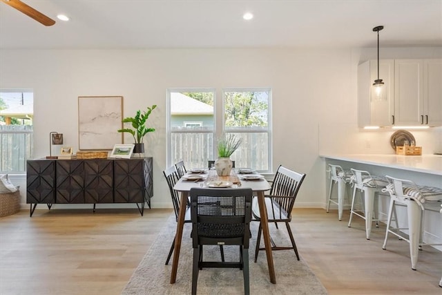 dining room featuring light hardwood / wood-style floors and ceiling fan