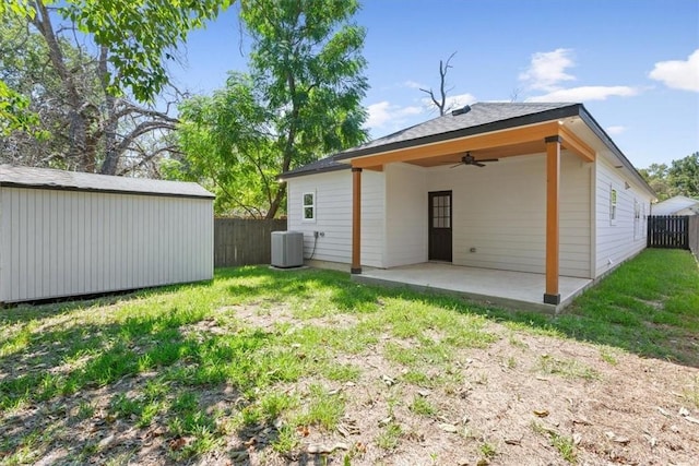 rear view of property with central air condition unit, a patio area, ceiling fan, and a lawn