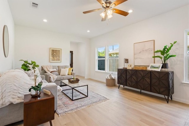 living room with light hardwood / wood-style floors and ceiling fan