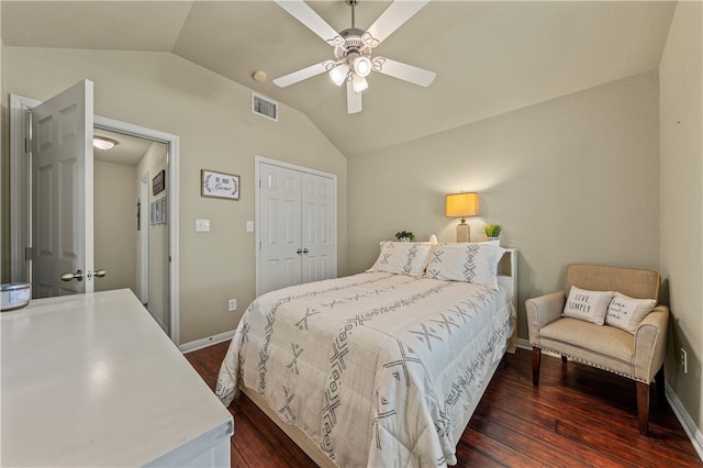 bedroom featuring visible vents, dark wood-type flooring, a closet, and vaulted ceiling