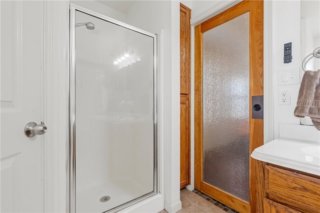 full bathroom with tile patterned flooring and a shower stall