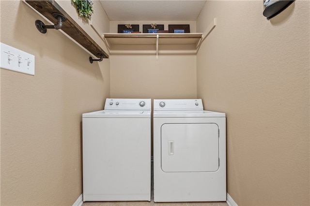 washroom featuring laundry area, washer and dryer, and baseboards