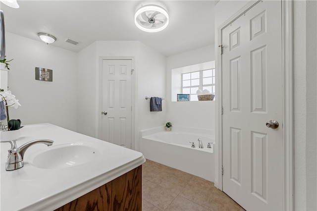 full bathroom featuring visible vents, a garden tub, a sink, tile patterned flooring, and double vanity