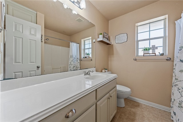 bathroom with vanity, baseboards, visible vents, tile patterned floors, and toilet