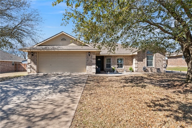 single story home featuring brick siding, concrete driveway, and a garage