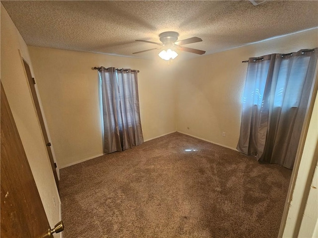 unfurnished bedroom featuring a textured ceiling, carpet flooring, and a ceiling fan