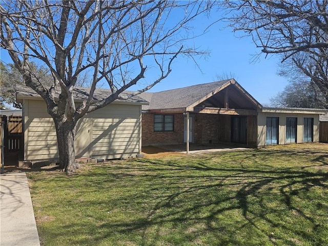 view of front of home with a front yard and brick siding