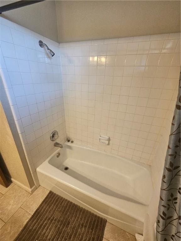 bathroom with shower / bath combination with curtain and tile patterned flooring