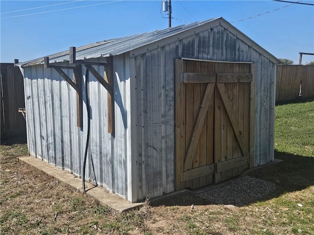 view of shed featuring fence