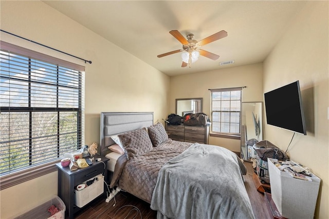 bedroom with ceiling fan and dark hardwood / wood-style floors