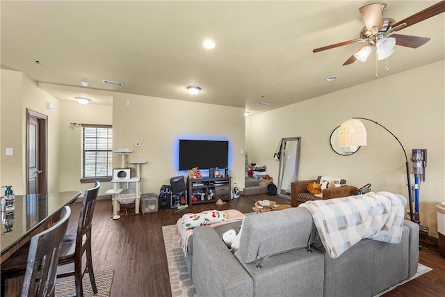 living room featuring dark hardwood / wood-style floors and ceiling fan