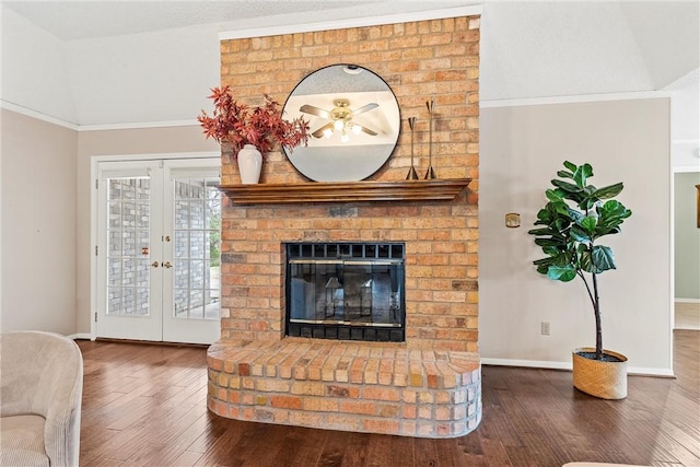 living room with french doors, a fireplace, wood finished floors, and baseboards