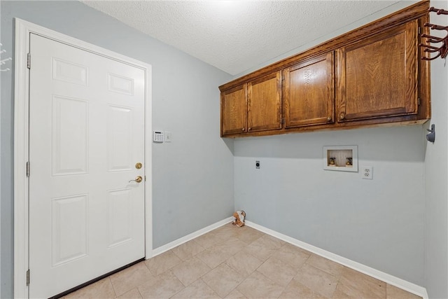 laundry area with a textured ceiling, washer hookup, baseboards, cabinet space, and electric dryer hookup