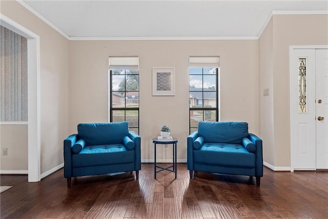 living area featuring ornamental molding, hardwood / wood-style floors, and baseboards