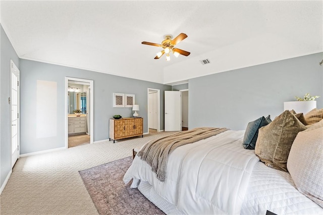 carpeted bedroom with ceiling fan, lofted ceiling, connected bathroom, visible vents, and baseboards