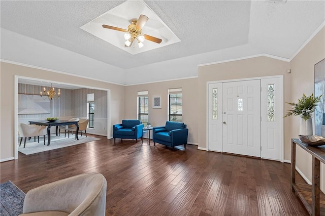 entrance foyer featuring a textured ceiling, a tray ceiling, and dark wood-style flooring