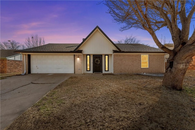 ranch-style home with concrete driveway, brick siding, roof with shingles, and an attached garage