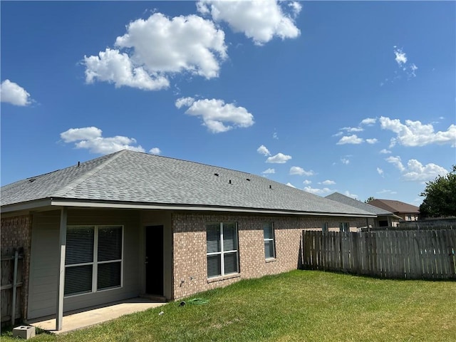 back of property featuring a yard