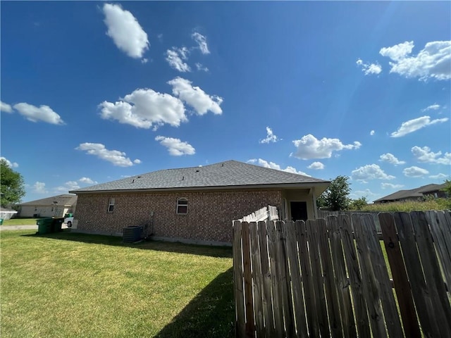 view of property exterior with a lawn and cooling unit