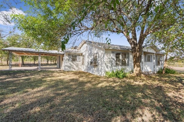 view of front facade with a front yard and a carport