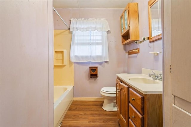 full bathroom featuring bathing tub / shower combination, toilet, vanity, and hardwood / wood-style flooring