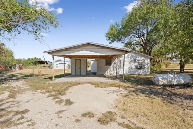 rear view of house featuring a carport