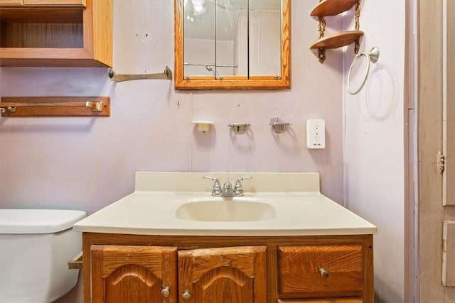 bathroom featuring vanity and toilet