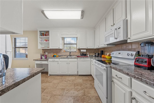 kitchen featuring backsplash, white cabinetry, sink, and white appliances