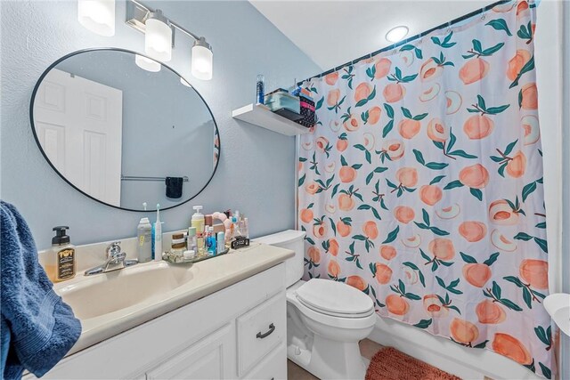 full bathroom featuring shower / bathtub combination with curtain, vanity, and toilet