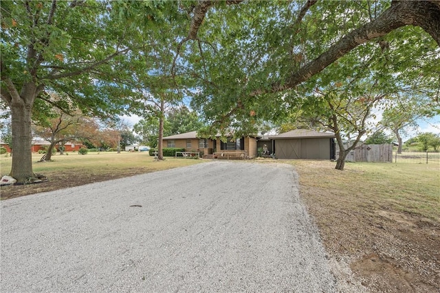 ranch-style home with a front lawn