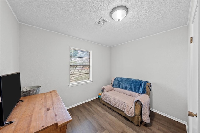 office area featuring a textured ceiling, dark hardwood / wood-style flooring, and crown molding