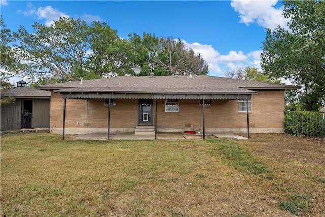 back of house with a patio and a lawn