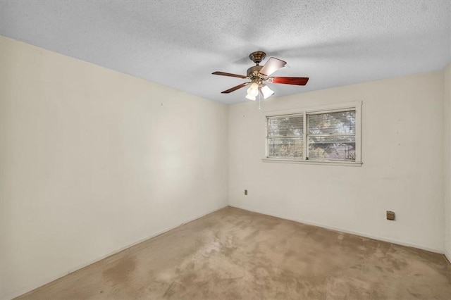 carpeted empty room with a textured ceiling