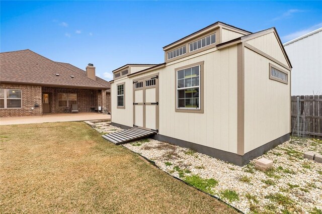 view of yard with an outbuilding, a patio area, and a fenced backyard