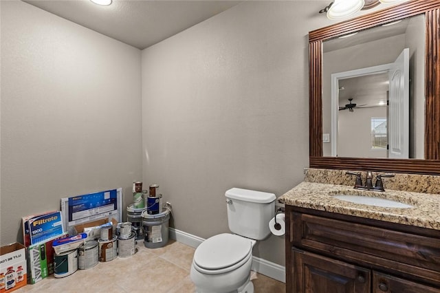 half bath featuring toilet, tile patterned flooring, baseboards, and vanity