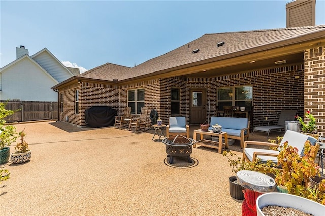 view of patio / terrace featuring an outdoor living space with a fire pit, fence, and area for grilling